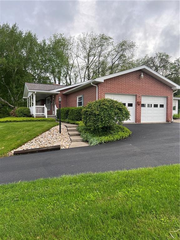 383 Bonniebrook Road Butler, PA 16002 - Photo 4 of 25 a front view of a house with a yard and garage