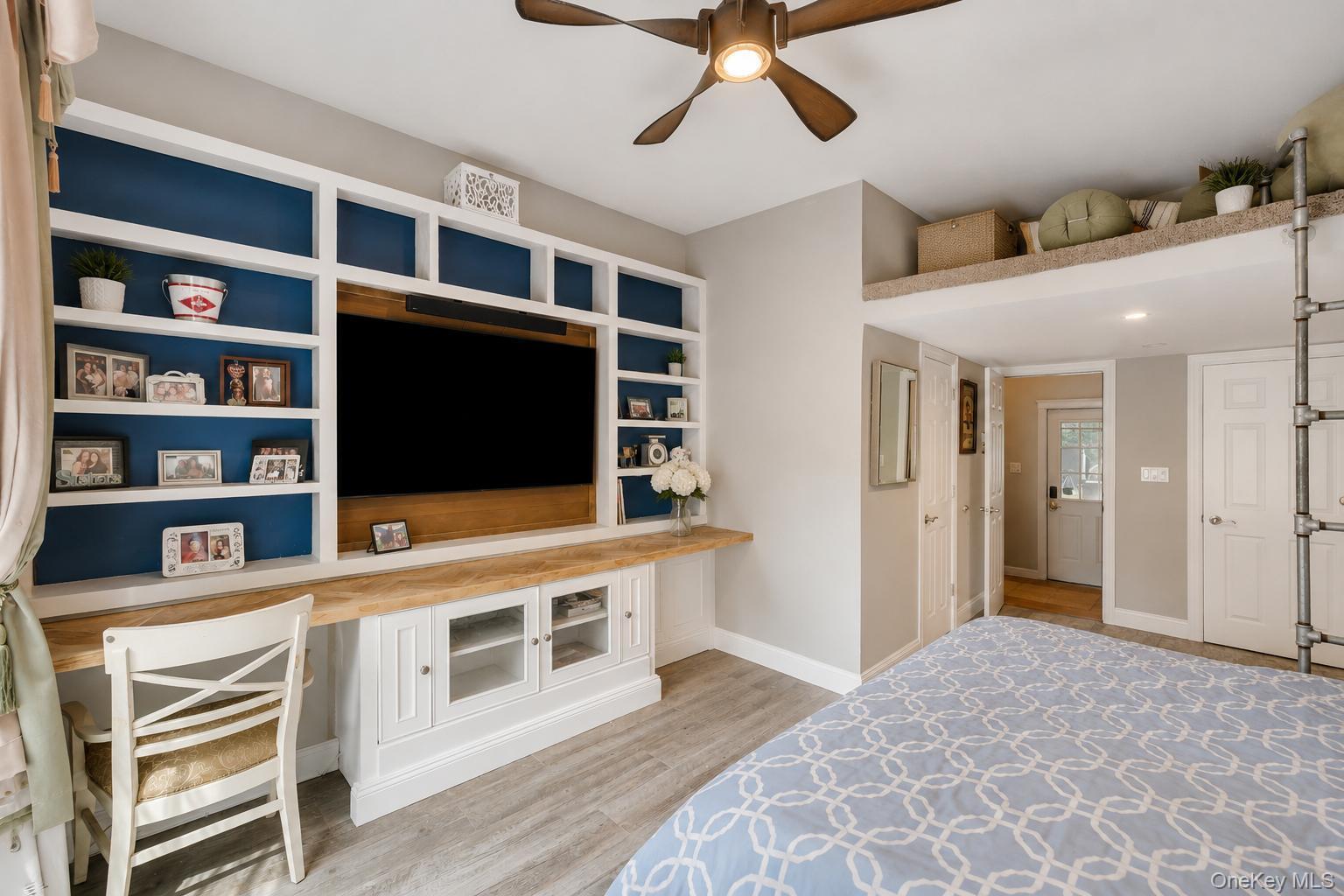 19 Joan Road Bay Shore, NY 11706 - Photo 22 of 50 Custom built-in shelving with integrated media center, wood-finish flooring, recessed lighting, and a ceiling fan with light fixture