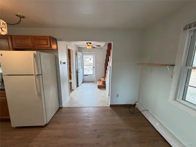 a view of a storage & utility room with a refrigerator