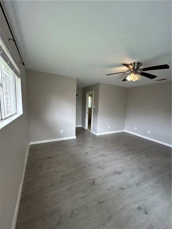 1613 Cheyenne Street Portland, TX 78374 - Photo 15 of 25 an empty room with a chandelier fan and windows