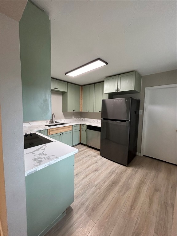 1613 Cheyenne Street Portland, TX 78374 - Photo 9 of 25 a kitchen with stainless steel appliances granite countertop a refrigerator a sink and a stove