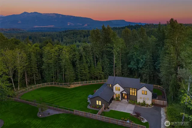 a view of a house with garden and a sitting area