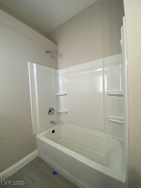 3702 River Canyon Road Las Vegas, NV 89129 - Photo 13 of 35 Full bathroom with washtub / shower combination and wood finished floors upstairs shred