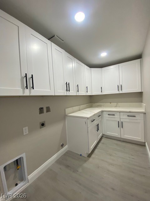 3702 River Canyon Road Las Vegas, NV 89129 - Photo 19 of 35 Laundry room featuring cabinet space, light wood-type flooring, electric dryer hookup, and recessed lighting