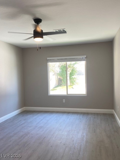 3702 River Canyon Road Las Vegas, NV 89129 - Photo 24 of 35 1-down Unfurnished room featuring light wood-style floors and ceiling fan down