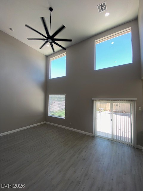3702 River Canyon Road Las Vegas, NV 89129 - Photo 25 of 35 Empty room with a high ceiling, dark wood-type flooring, and ceiling fan