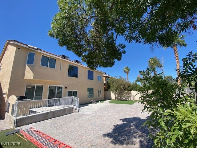 3702 River Canyon Road Las Vegas, NV 89129 - Photo 28 of 35 Rear view of house featuring a patio area, stucco siding, and a fenced backyard