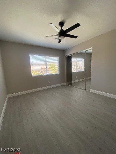 3702 River Canyon Road Las Vegas, NV 89129 - Photo 8 of 35 Unfurnished bedroom featuring light wood-style floors, a closet, and a ceiling fan