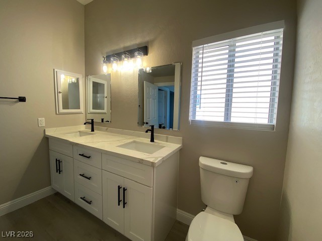 3702 River Canyon Road Las Vegas, NV 89129 - Photo 10 of 35 Bathroom featuring double vanity and dark wood-type flooring