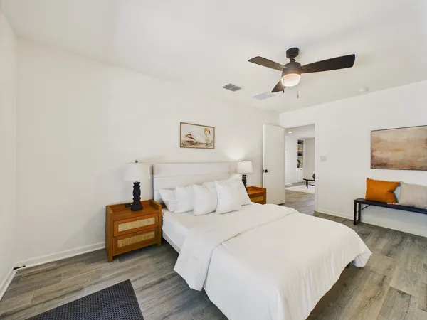 a bedroom with bed and a chandelier