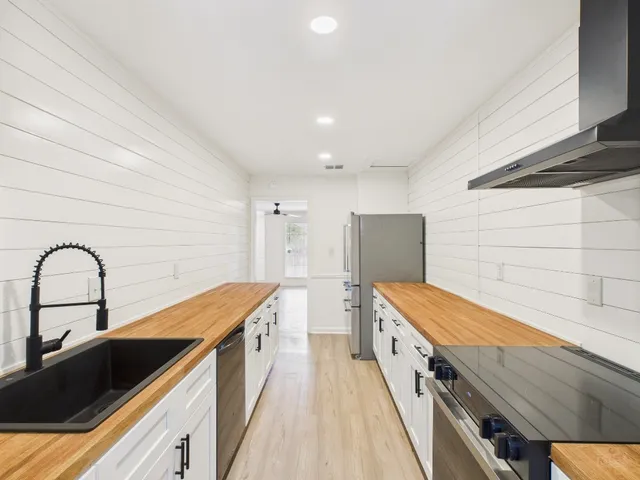 a kitchen with stainless steel appliances a stove and a refrigerator