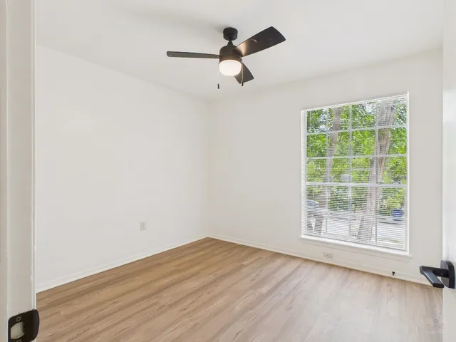 a view of a room with wooden floor and white cabinet