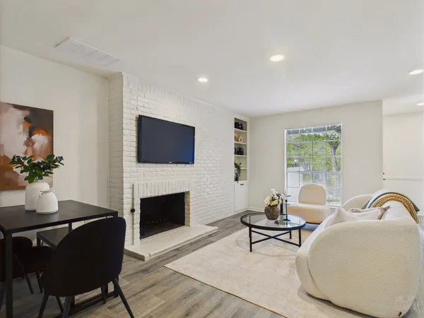 a living room with furniture a fireplace and a flat screen tv