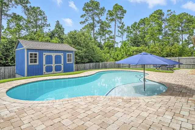 an empty room with a ceiling fan and window