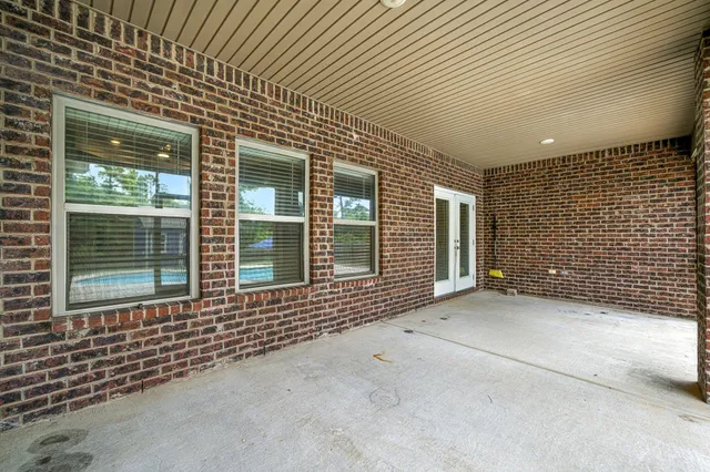 a bathroom with a granite countertop sink toilet mirror and a bathtub