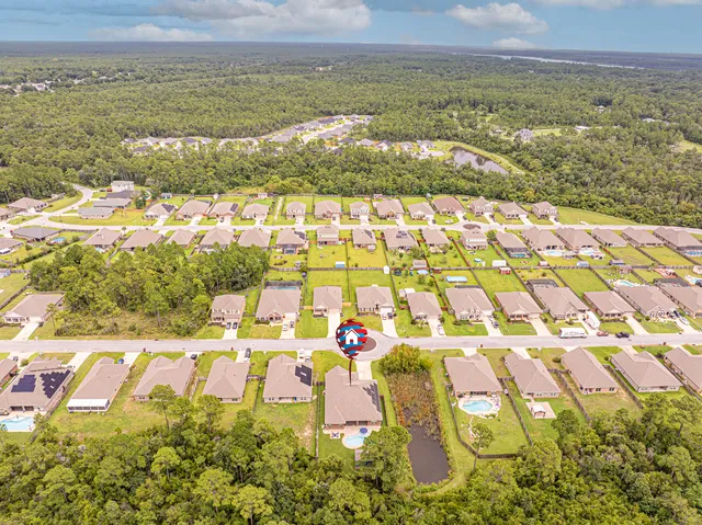 a kitchen with stainless steel appliances granite countertop a sink and a stove with wooden floor