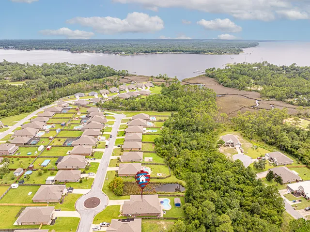a view of a kitchen with stainless steel appliances a large counter top