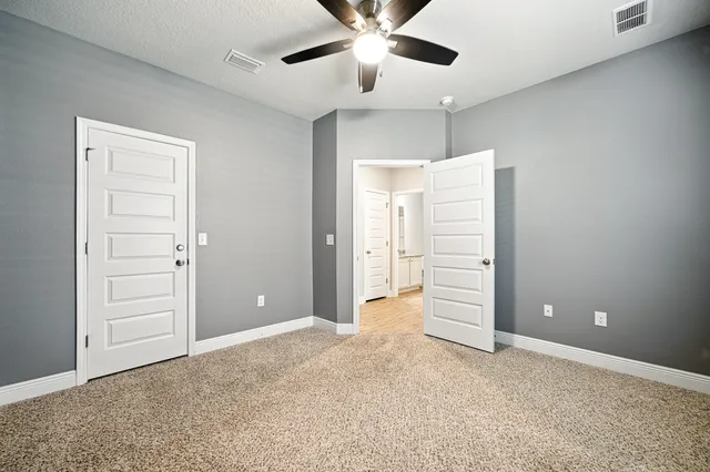 a kitchen with granite countertop white cabinets and white stainless steel appliances