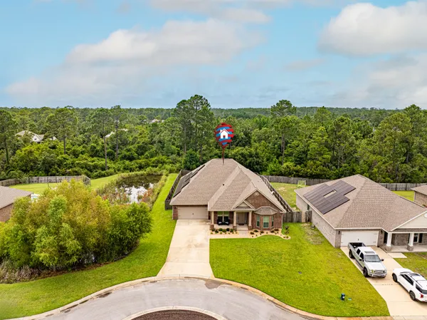 a view of a house with swimming pool and a chairs