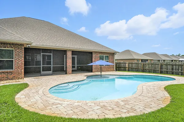 a view of a patio with a table and chairs and floor to ceiling window
