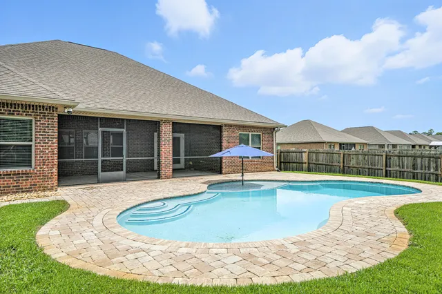 a view of a patio with a table and chairs and floor to ceiling window