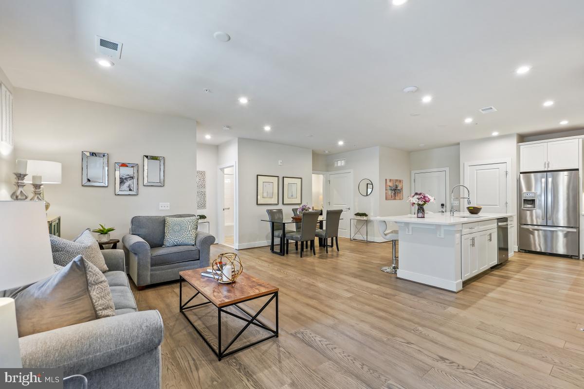 2319 Field Point Road, Unit 107 Herndon, VA 20171 - Photo 1 of 30 a living room with furniture kitchen view and a wooden floor