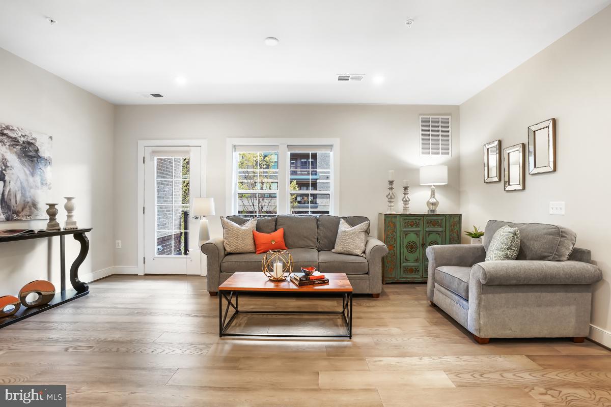 2319 Field Point Road, Unit 107 Herndon, VA 20171 - Photo 11 of 30 a living room with furniture and a window