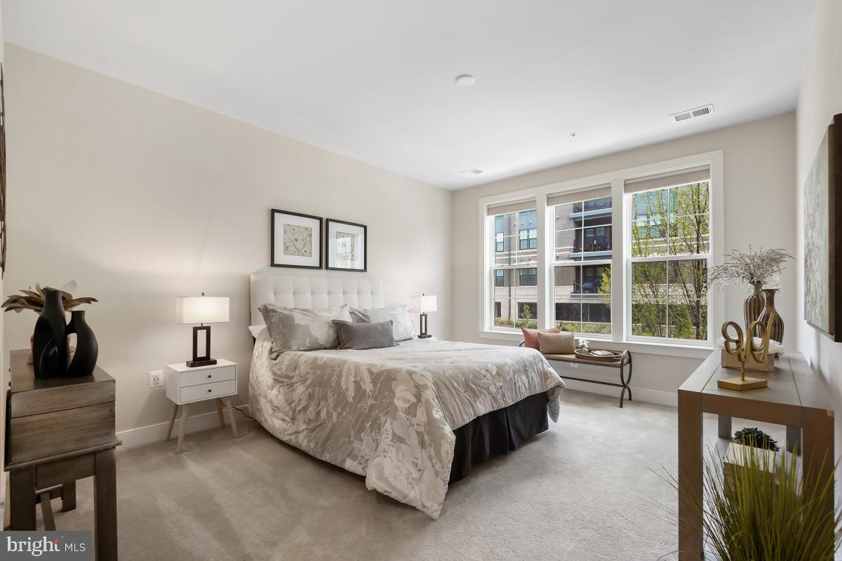 2319 Field Point Road, Unit 107 Herndon, VA 20171 - Photo 12 of 30 a bedroom with a bed a table and large window