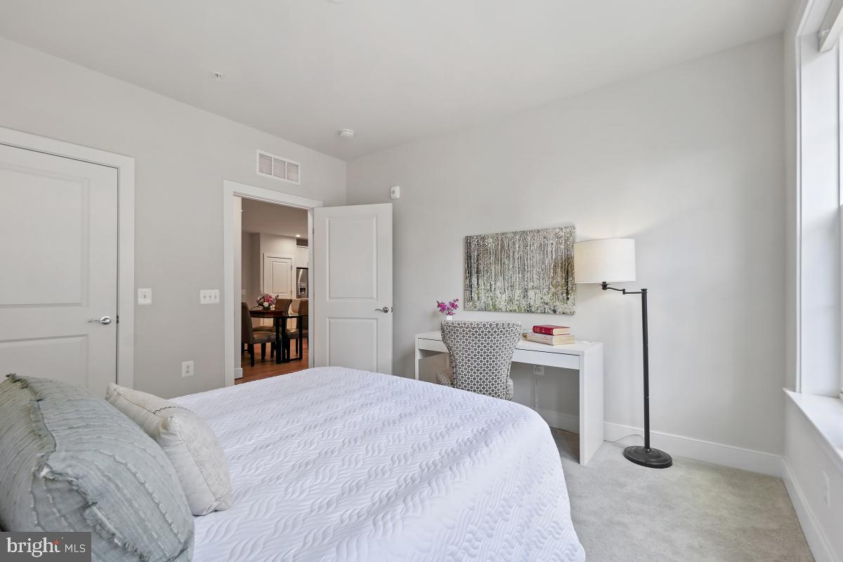 2319 Field Point Road, Unit 107 Herndon, VA 20171 - Photo 19 of 30 a bedroom with a bed and a chandelier