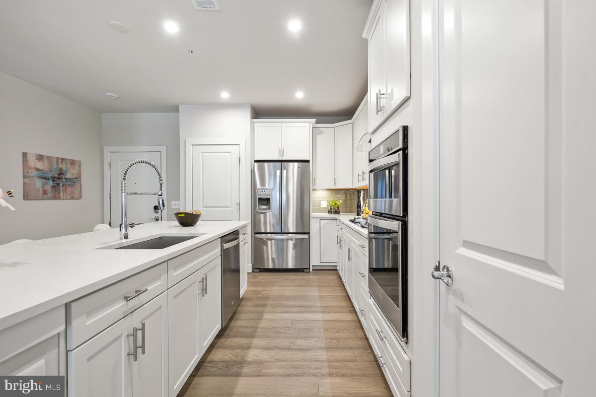 2319 Field Point Road, Unit 107 Herndon, VA 20171 - Photo 5 of 30 a large kitchen with a sink and refrigerator