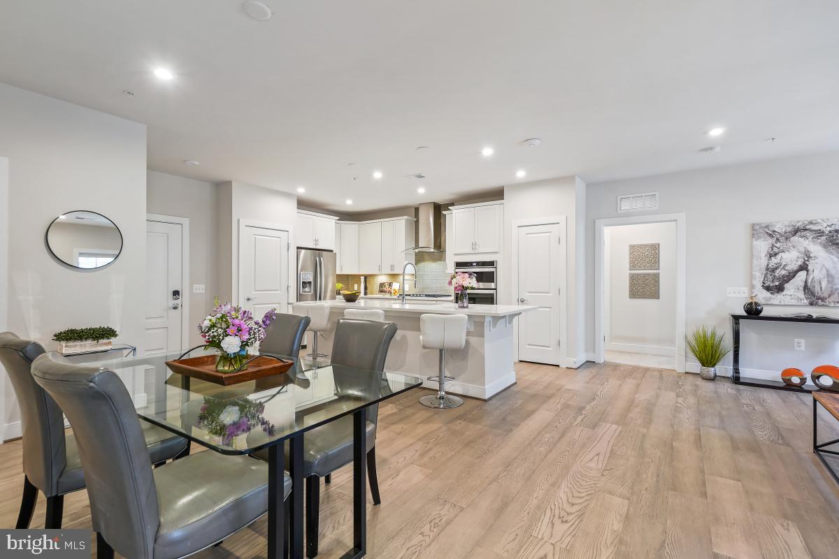 2319 Field Point Road, Unit 107 Herndon, VA 20171 - Photo 10 of 30 a dining room with kitchen island stainless steel appliances furniture a dining table and chairs