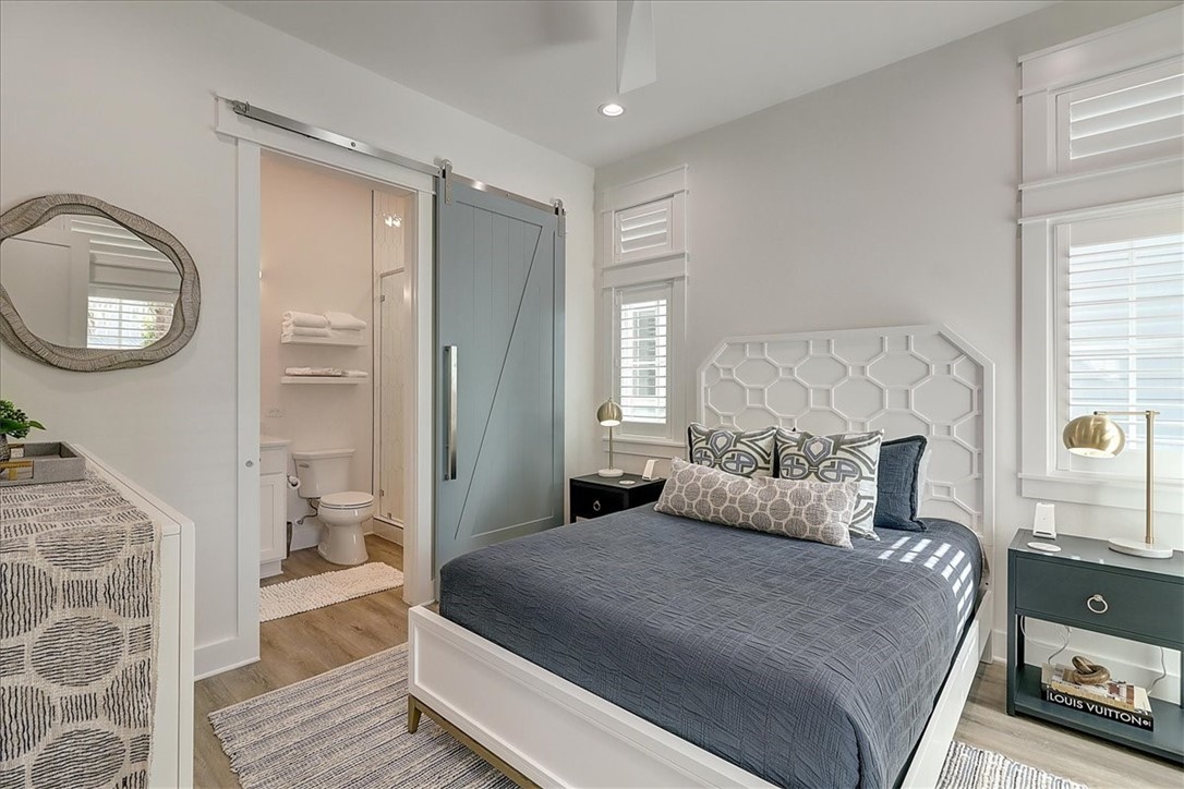 204 Round Road Port Aransas, TX 78373 - Photo 17 of 33 a bedroom with a large bed and a chandelier