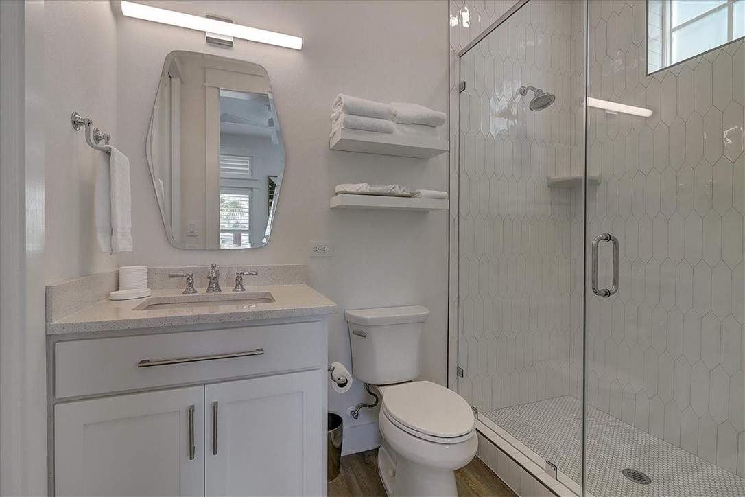 204 Round Road Port Aransas, TX 78373 - Photo 18 of 33 a bathroom with a granite countertop sink toilet and shower