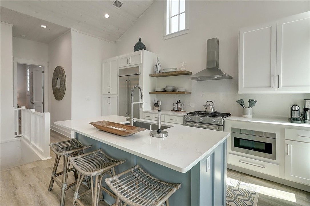 204 Round Road Port Aransas, TX 78373 - Photo 19 of 33 a kitchen with stainless steel appliances a stove a sink and cabinets
