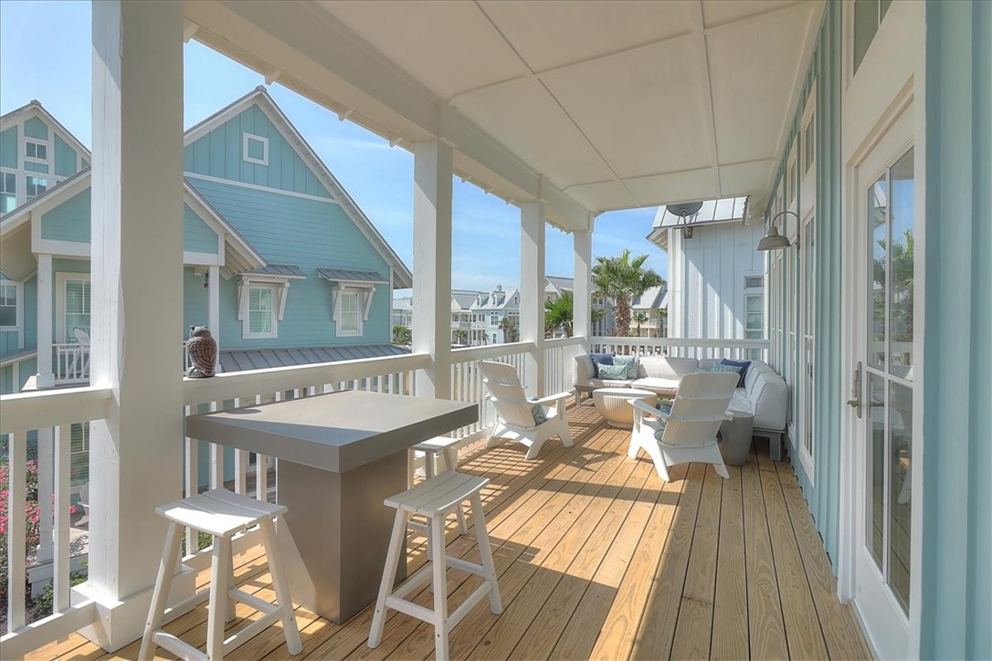 204 Round Road Port Aransas, TX 78373 - Photo 21 of 33 a dining room with furniture a chandelier and wooden floor