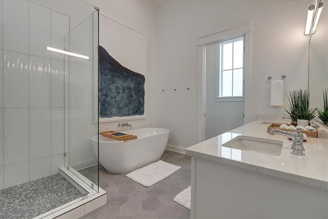 204 Round Road Port Aransas, TX 78373 - Photo 23 of 33 a bathroom with a bathtub a sink a window and vanity