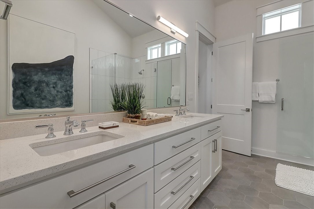 204 Round Road Port Aransas, TX 78373 - Photo 24 of 33 a bathroom with a double vanity sink and mirror