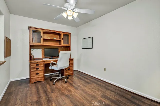 a view of a workspace with furniture and a window