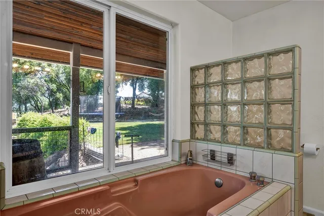 a bathroom with a tub and window