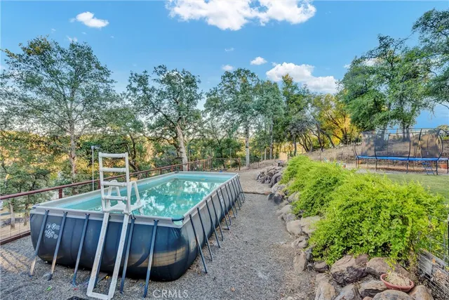 a view of a backyard with wooden fence