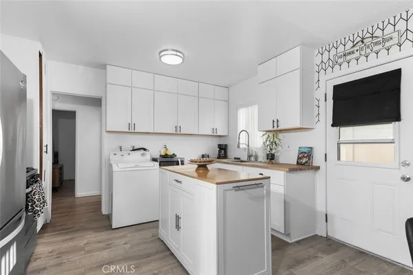 a kitchen with a stove a sink and a microwave