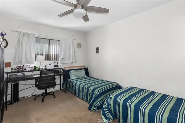 a bedroom with a bed a desk and chair