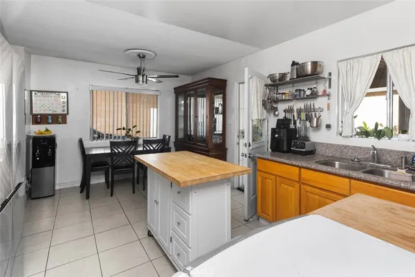 a kitchen with stainless steel appliances granite countertop a sink counter space and a window