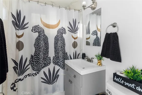 a bathroom with a sink a mirror and a shower