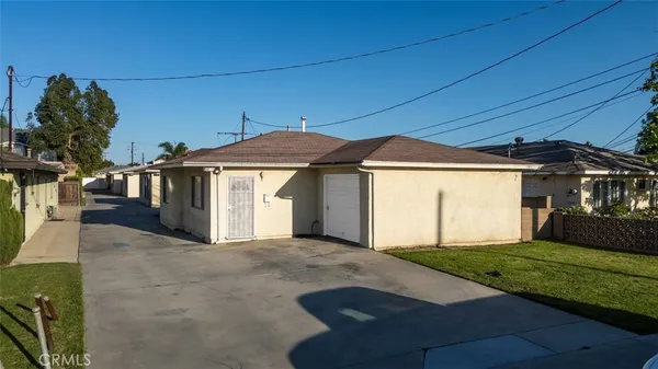 a front view of a house with a garden and yard