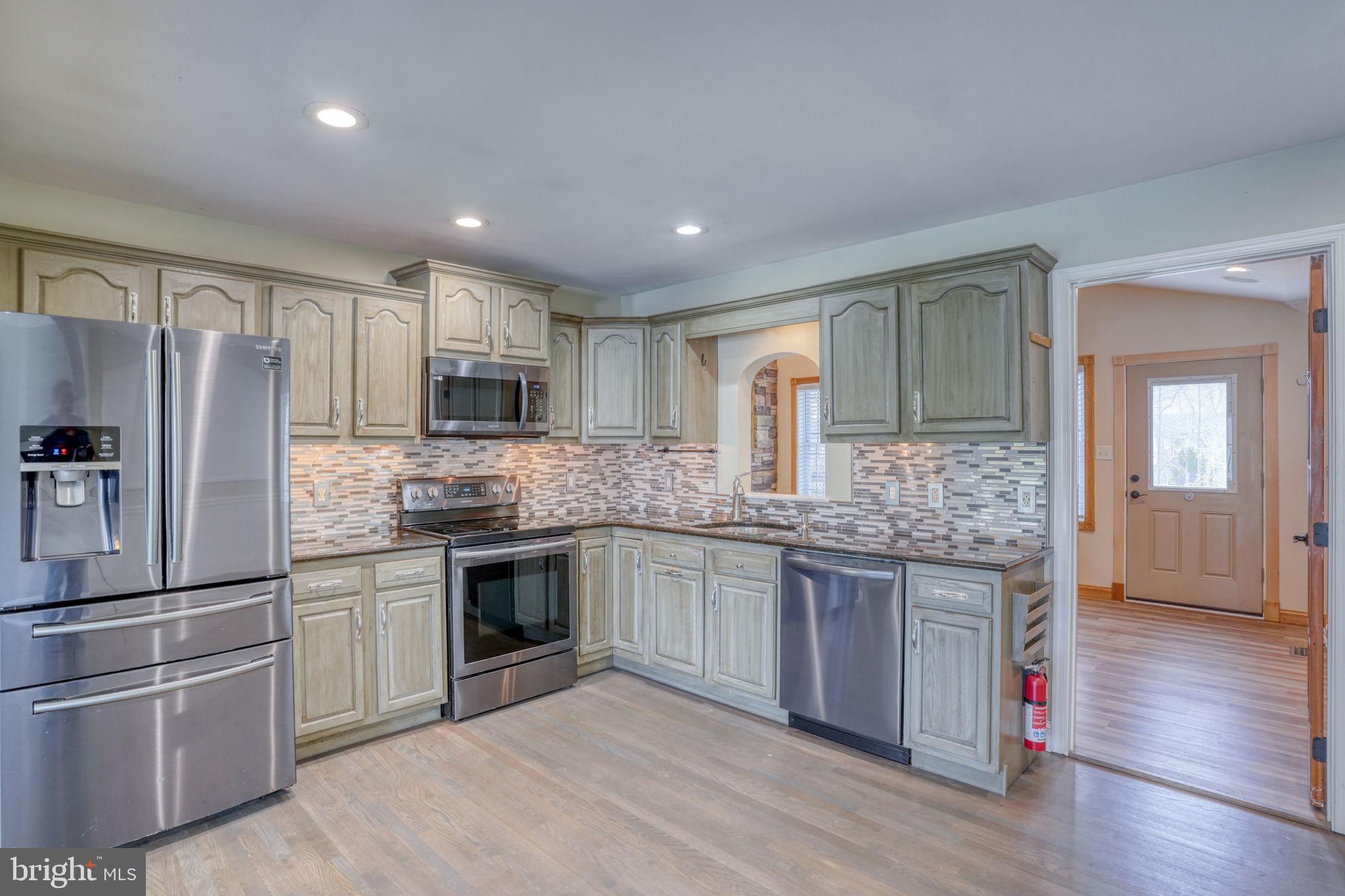 5 Kings Court Elkton, MD 21921 - Photo 7 of 47 a kitchen with stainless steel appliances granite countertop a refrigerator and a stove top oven