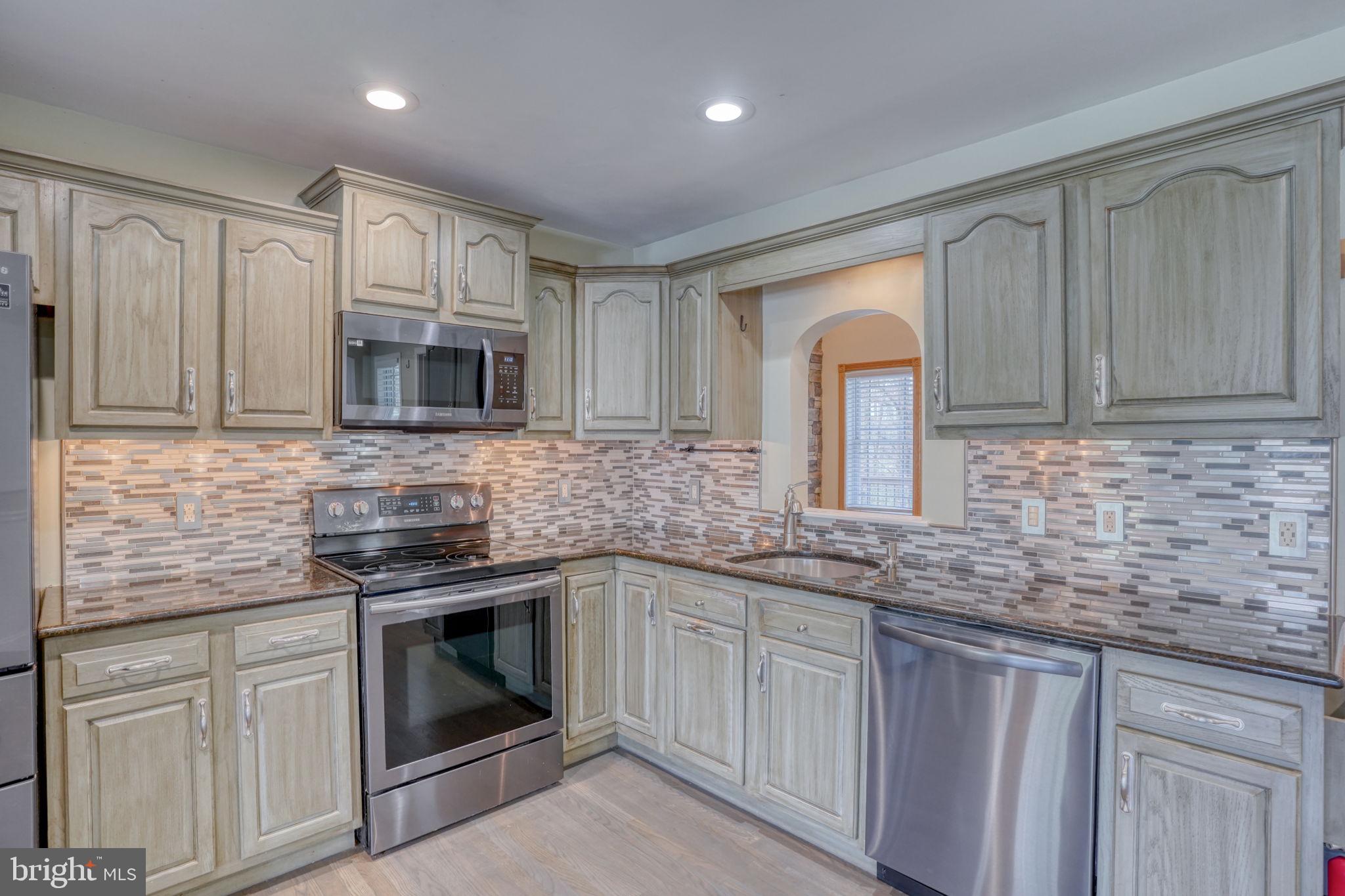 5 Kings Court Elkton, MD 21921 - Photo 8 of 47 a kitchen with stainless steel appliances granite countertop white cabinets granite counter tops and a wooden floors