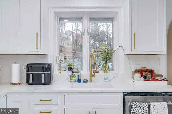 a kitchen with a sink a stove and cabinets