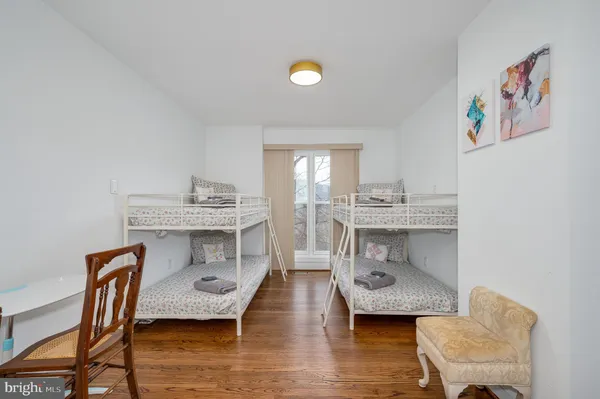 a bedroom with furniture and a flat screen tv