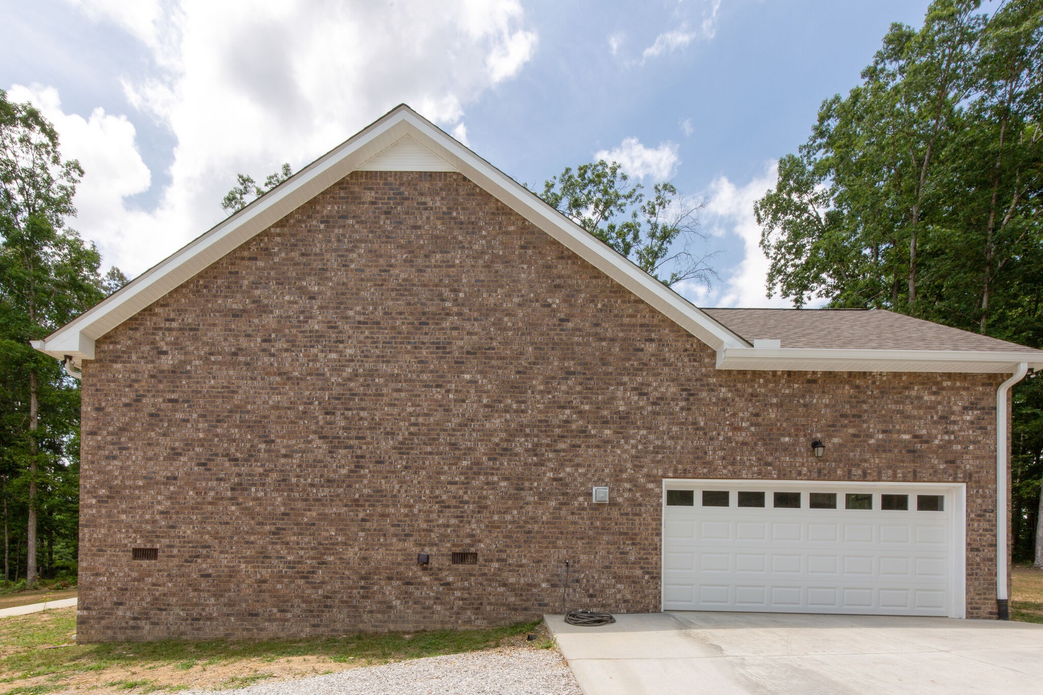 1079 Garton Road Burns, TN 37029 - Photo 3 of 25 a view of a stone house with a yard